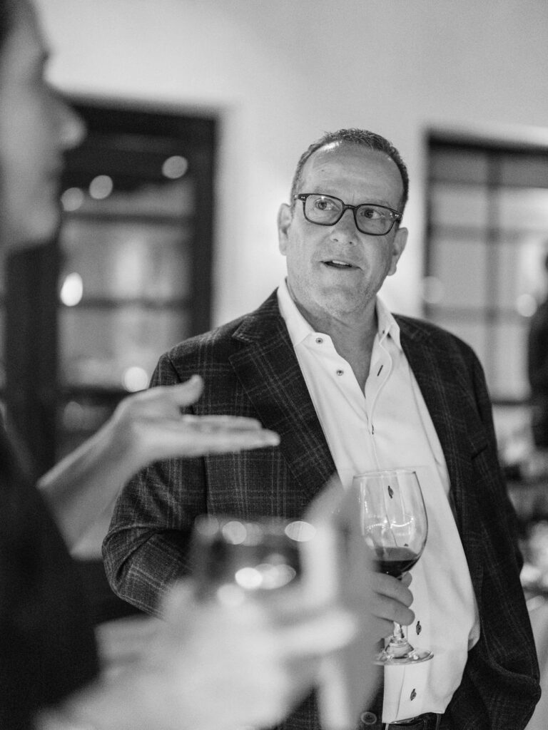 Black and white portrait of guest giving toast at El Chorro dinner