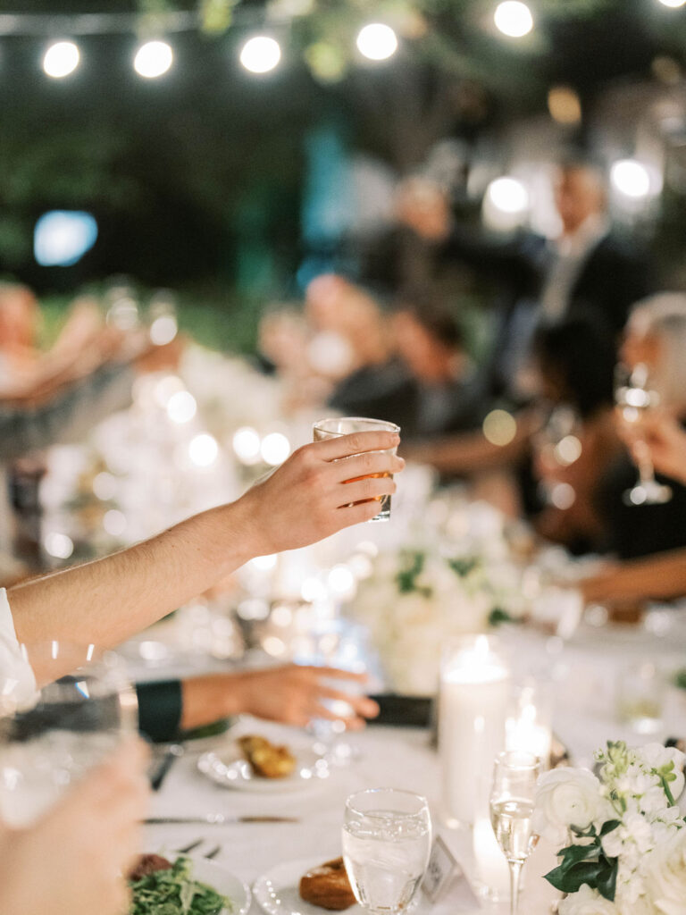 Guests toasting under string lights at El Chorro dinner
