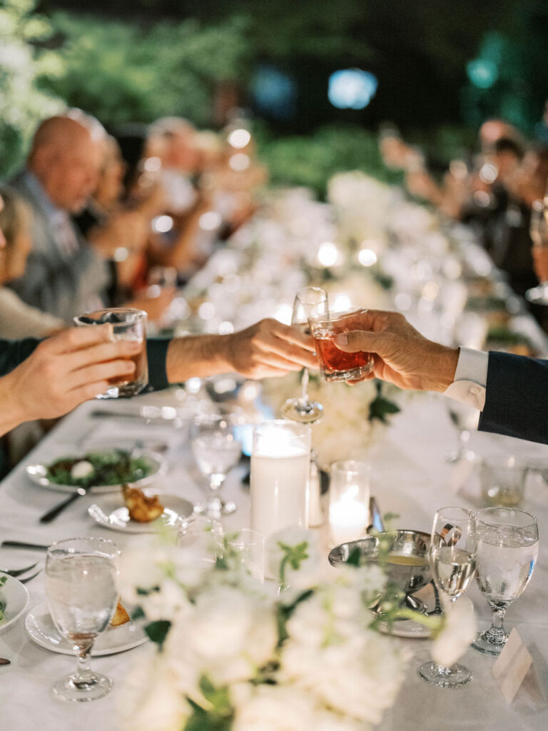 Guests clinking champagne glasses at El Chorro dinner event