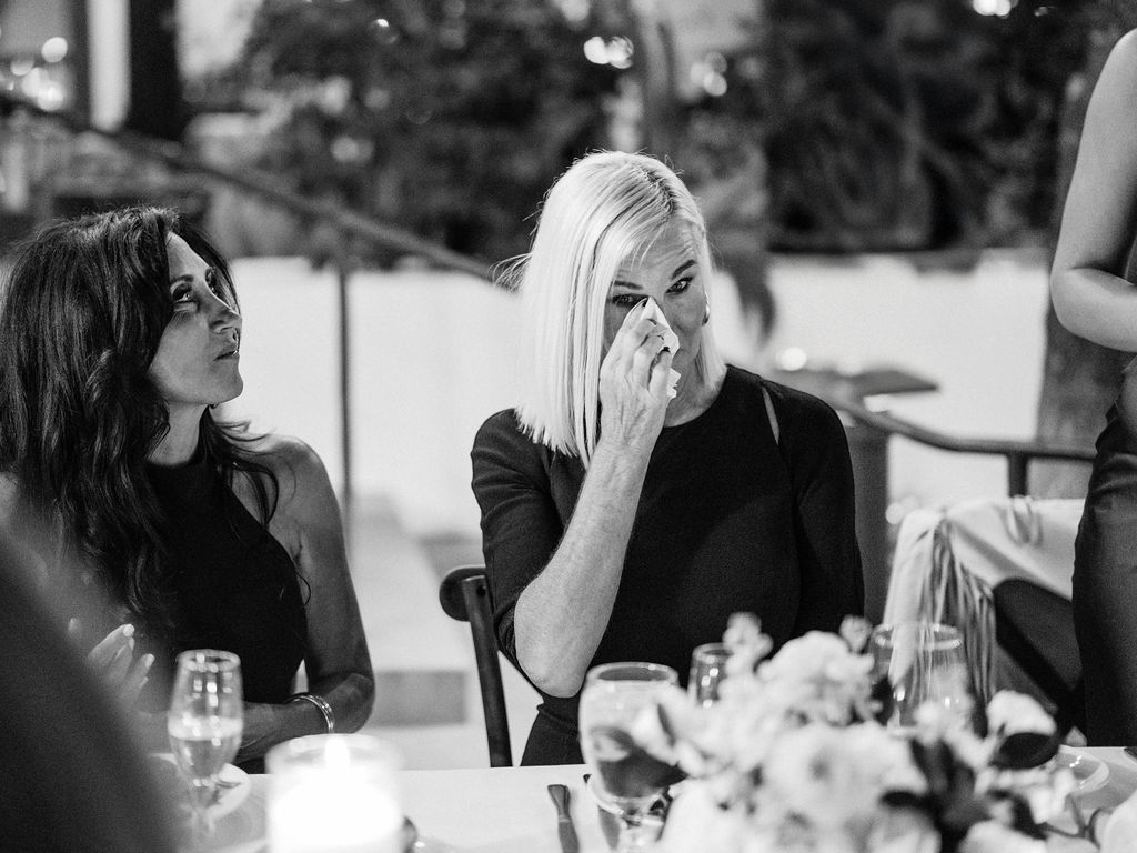 Black and white candid of guests talking at El Chorro dinner