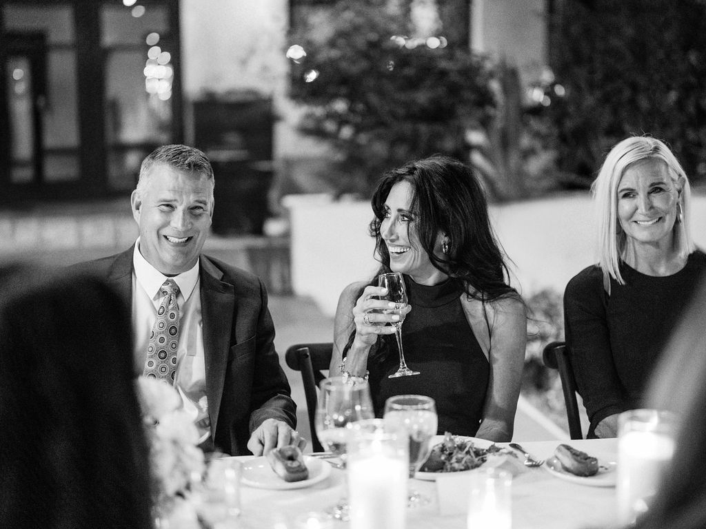 Guests smiling at El Chorro dinner party with drinks in hand