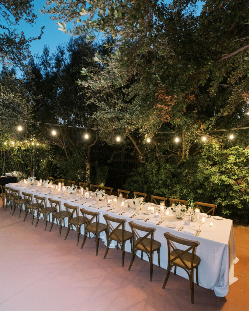 Dinner party table beneath string lights at El Chorro
