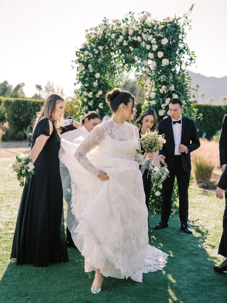Bride walking with bridesmaids before wedding ceremony at Andaz Scottsdale.