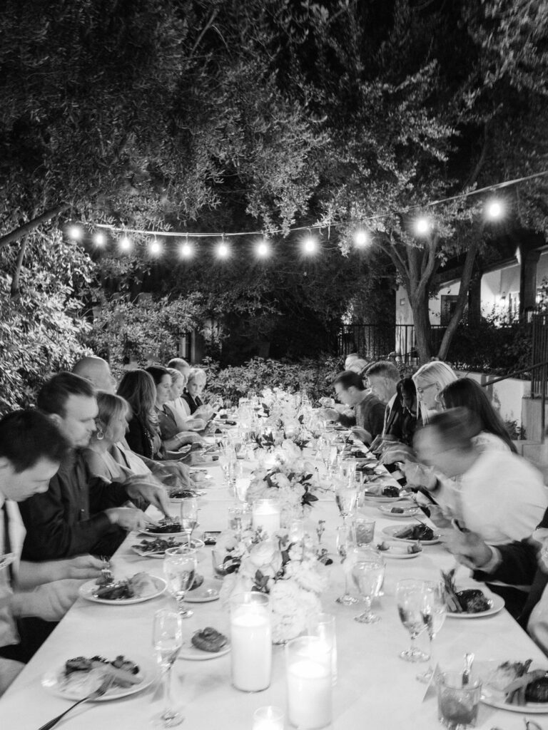 Black and white photo of guests dining at El Chorro dinner party