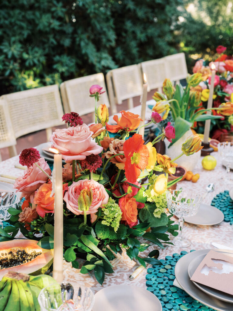 Wedding centerpiece with tropical fruit and florals at El Chorro.