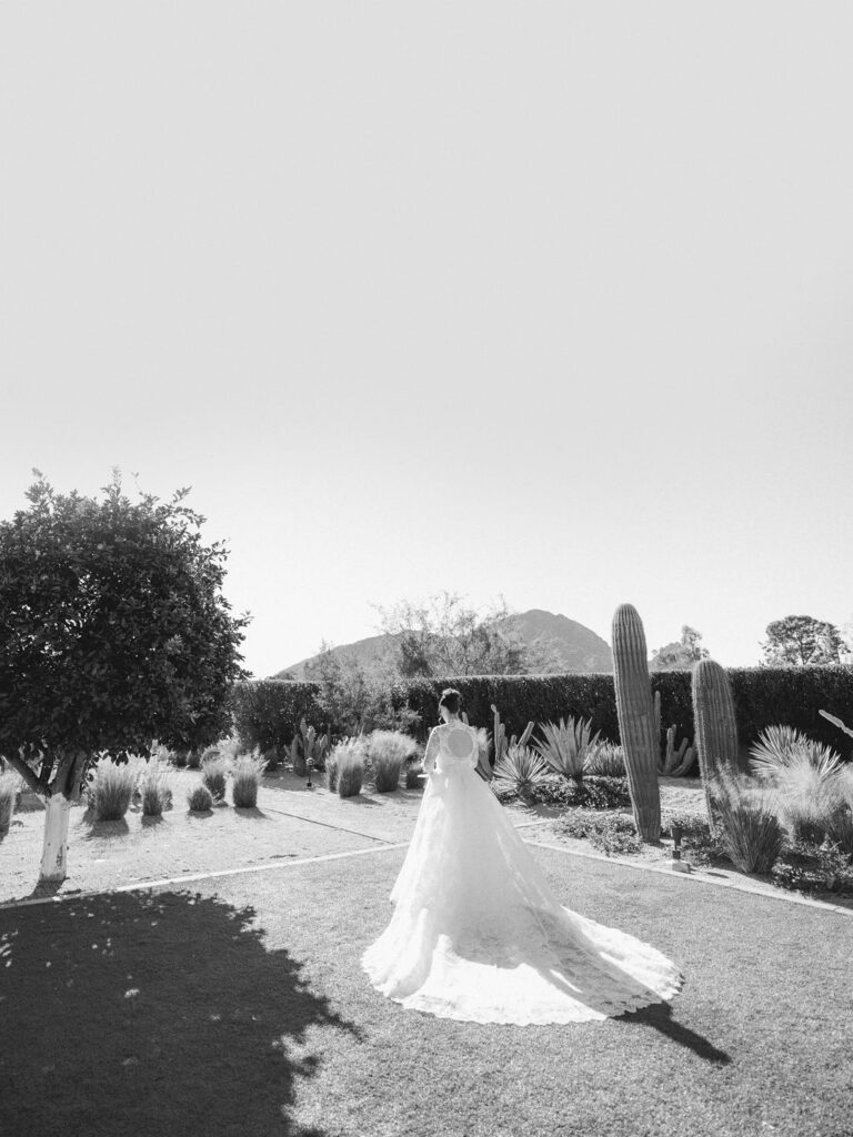 Black and white photo of bride walking outdoors at Andaz Scottsdale.