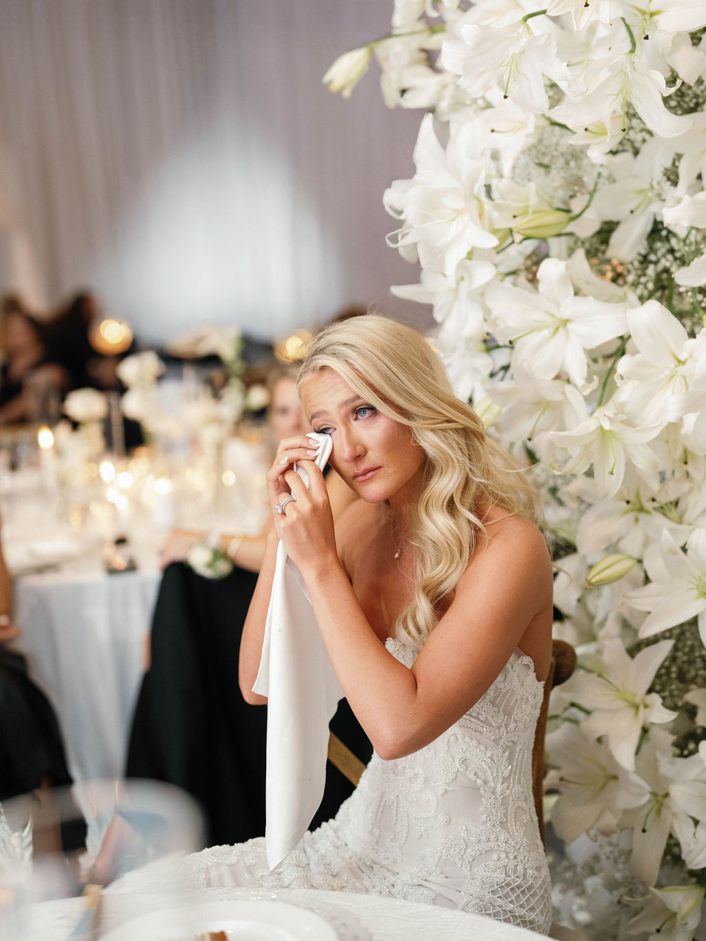 Bride wiping tears during reception toasts at Four Seasons Scottsdale
