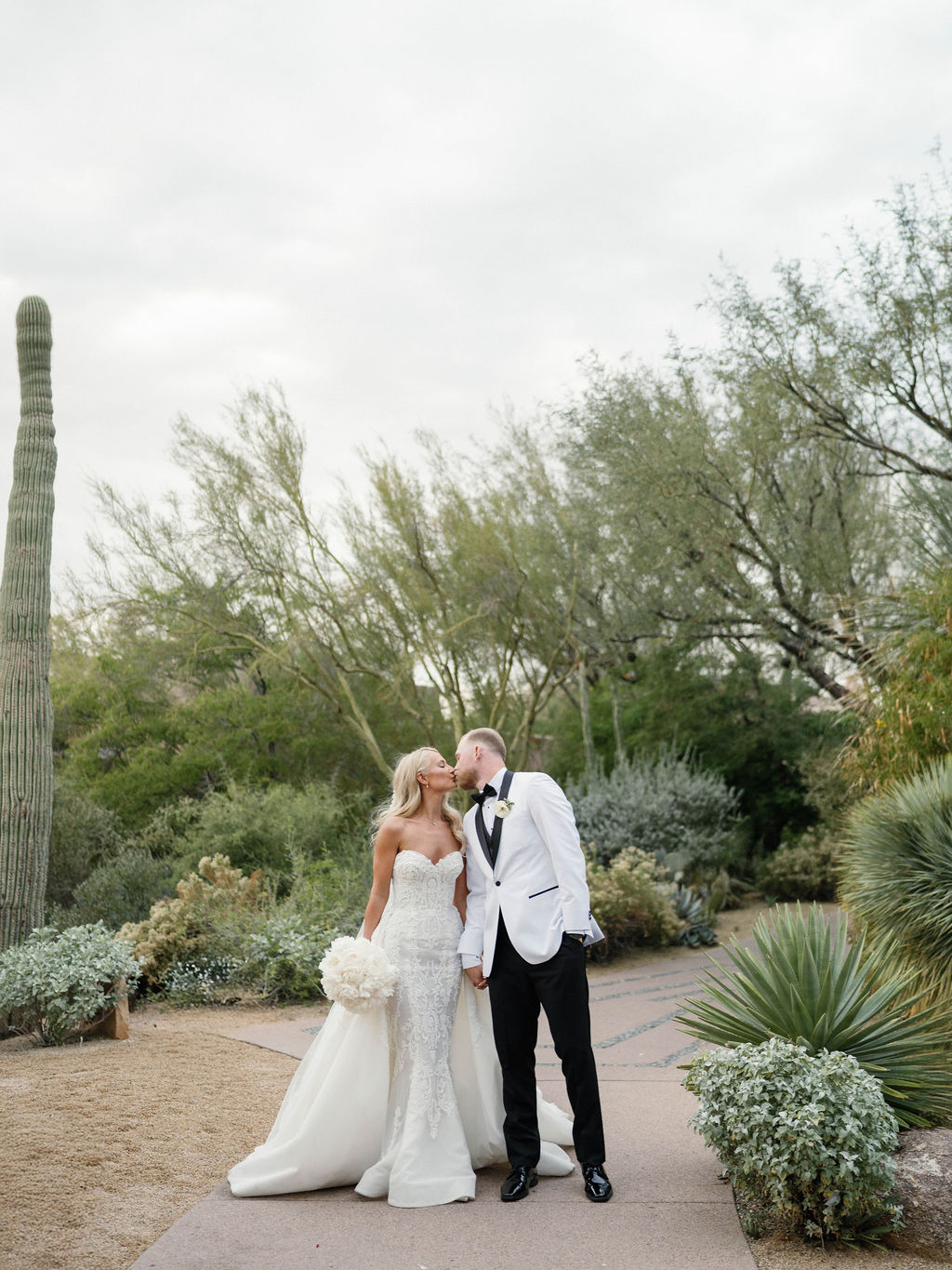 Couple kissing on desert path at Four Seasons Scottsdale