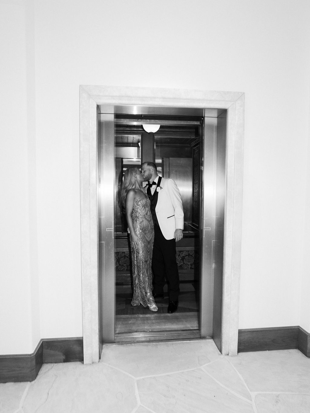 Black and white elevator kiss closing portrait at Four Seasons Scottsdale