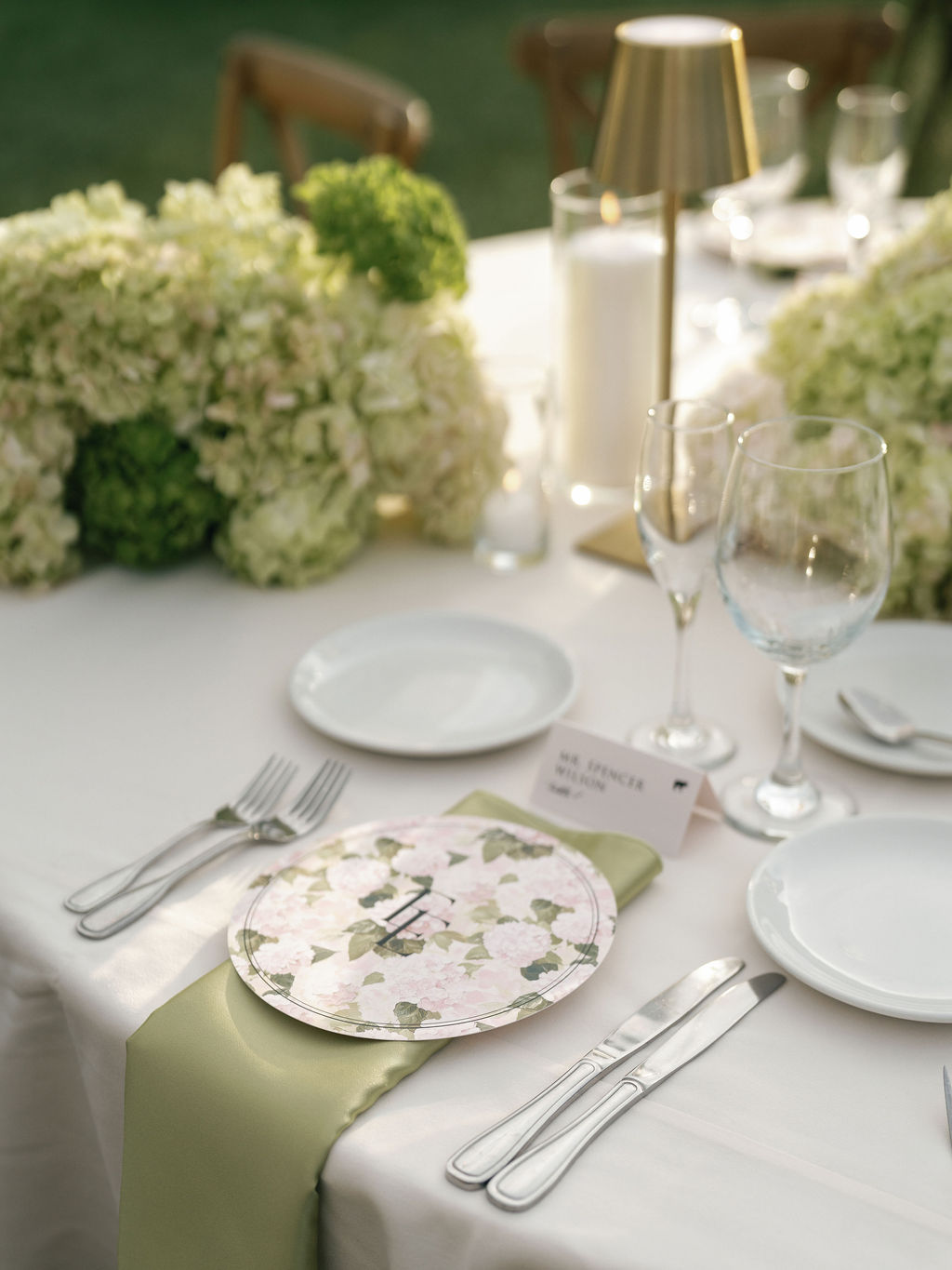 Elegant reception table setting with green linens and fine china at El Chorro wedding