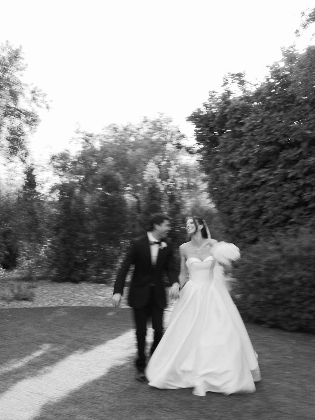 Bride and groom walking through garden path at El Chorro Paradise Valley