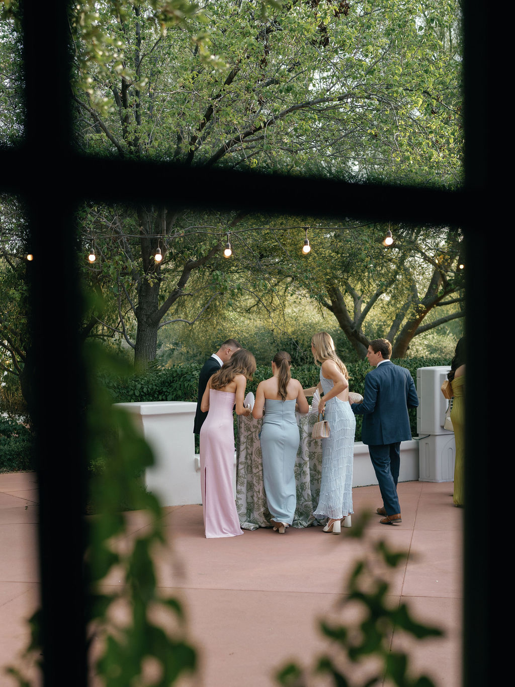 Erin and Evan sharing joyful moment surrounded by bougainvillea at El Chorro