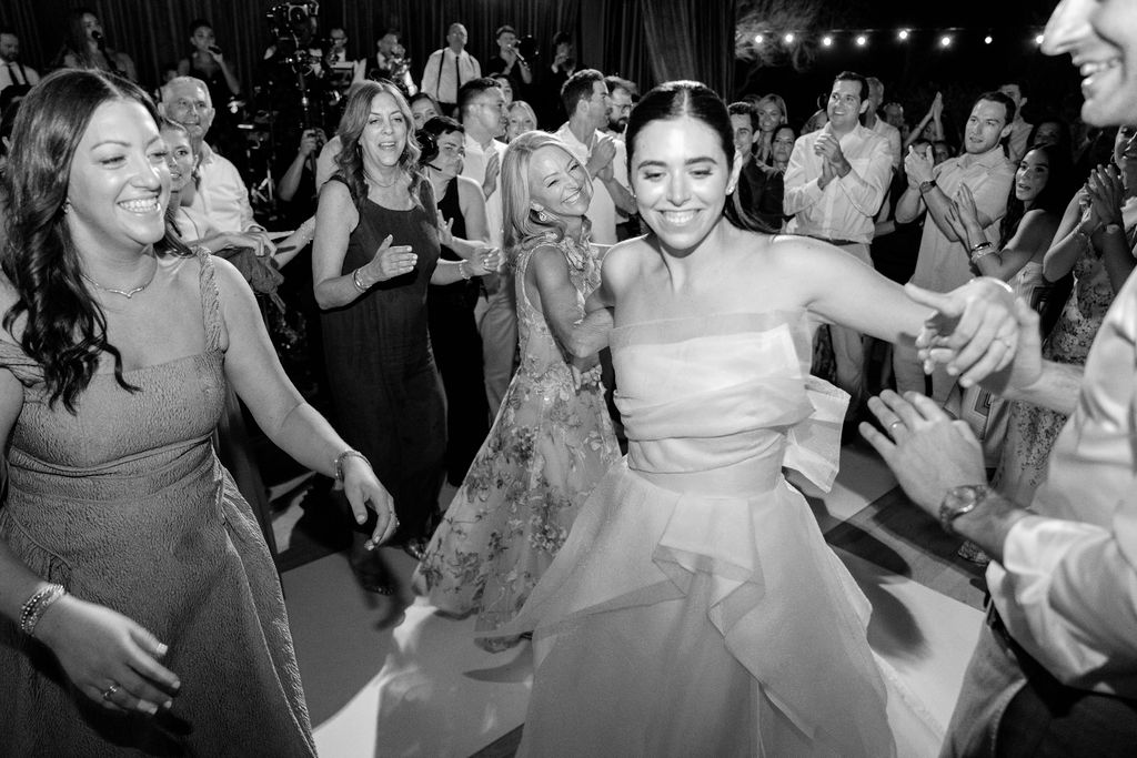 Bride dancing with her bridesmaids at the reception