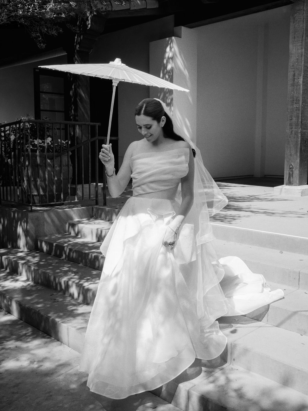 Bride on the stone steps at El Chorro with a parasol