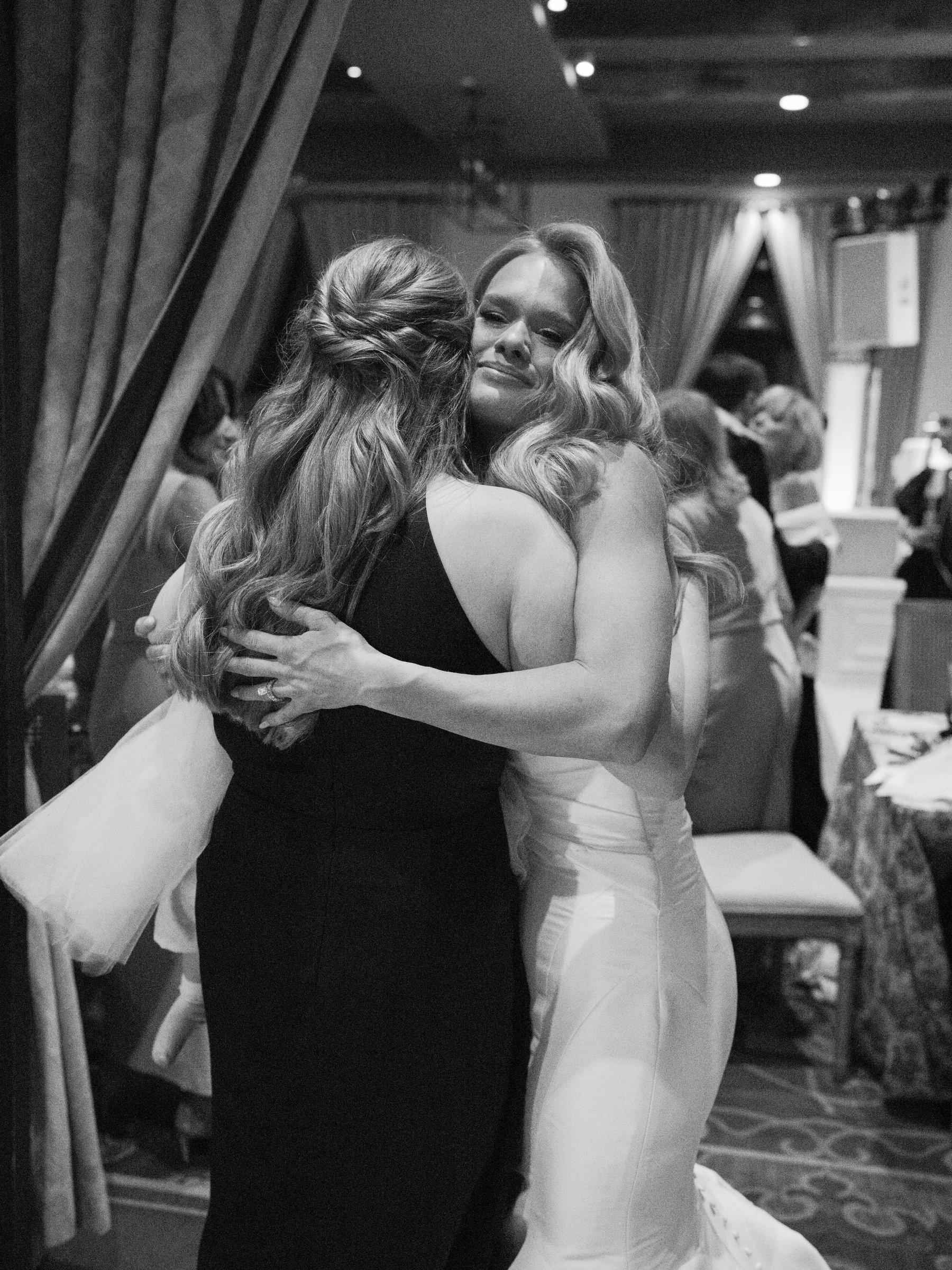 Meg embraces a guest during the reception