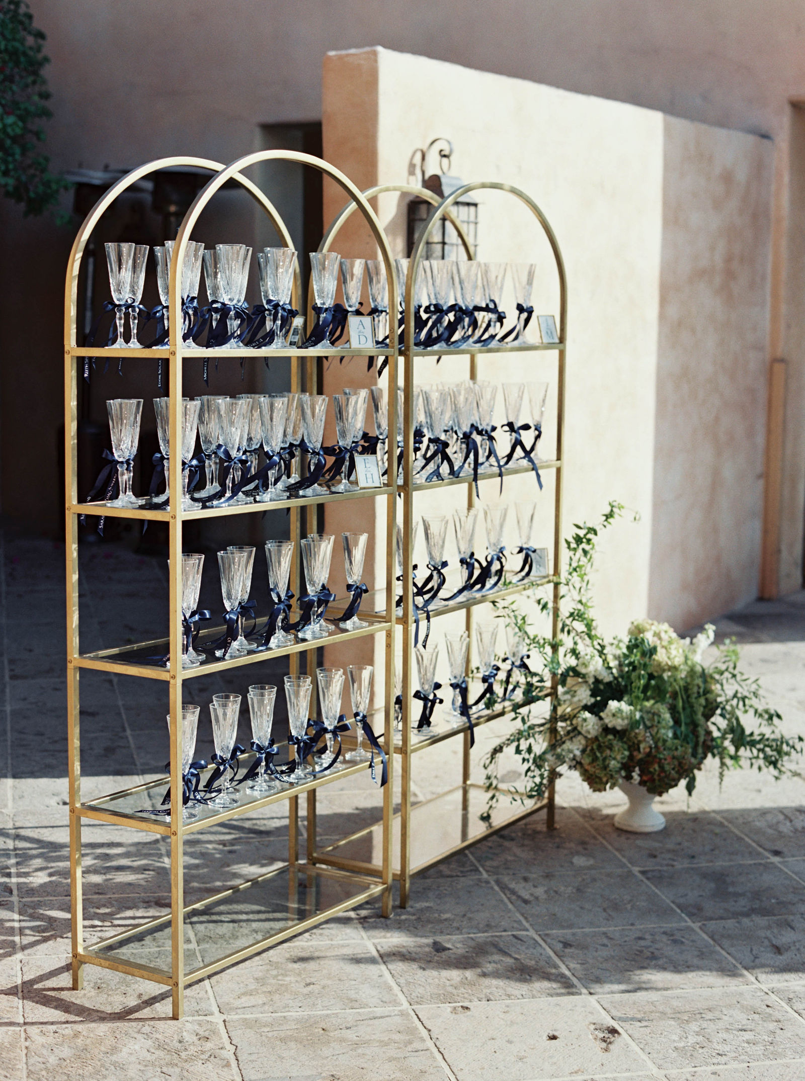 Champagne glasses tied with blue ribbon at the reception