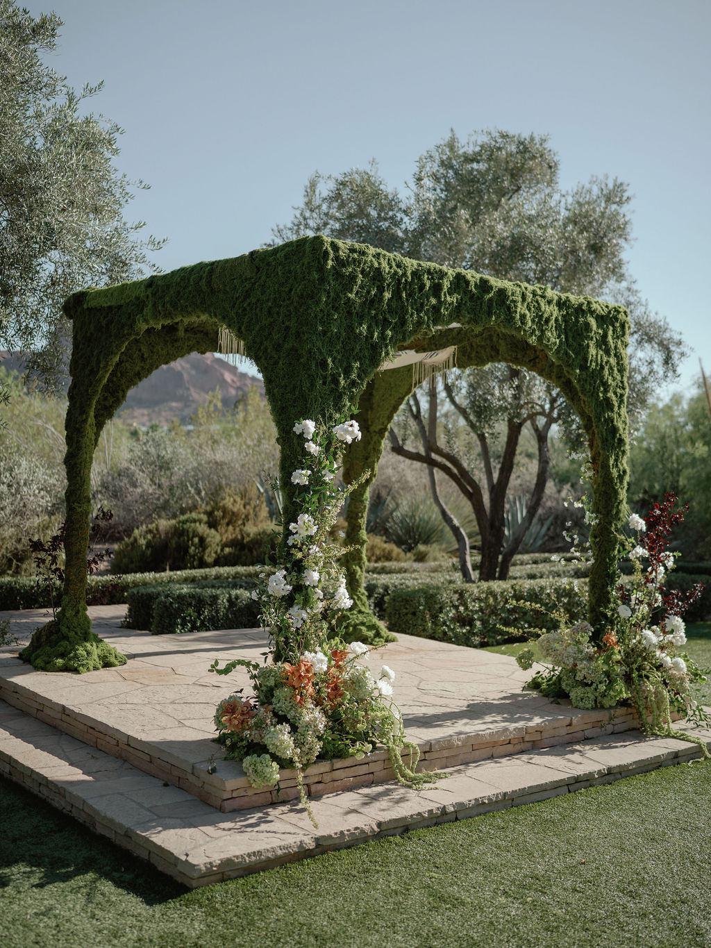 Moss-covered ceremony arch built for the chuppah at El Chorro