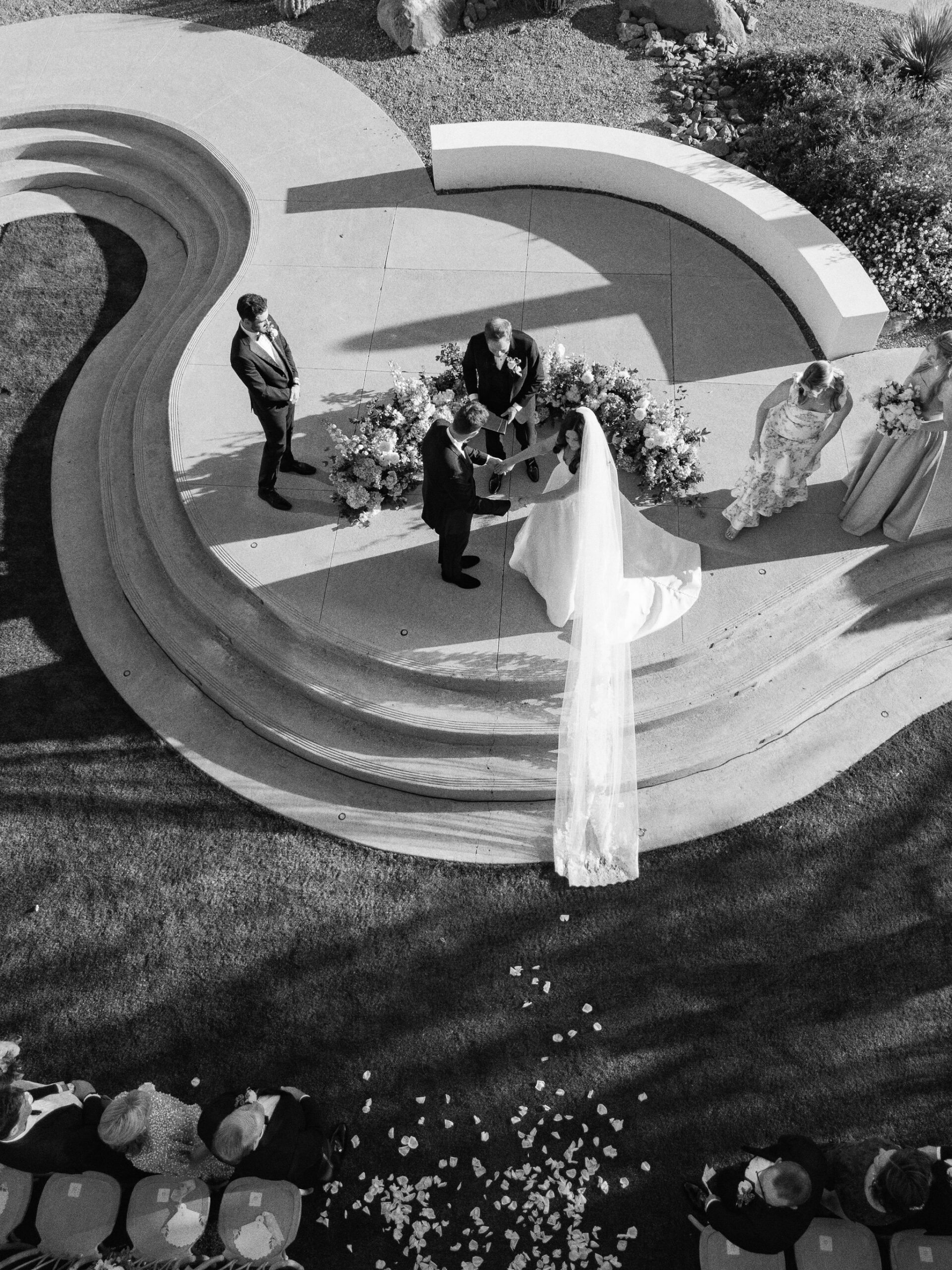 The ceremony seen from above, framed by curved concrete steps.