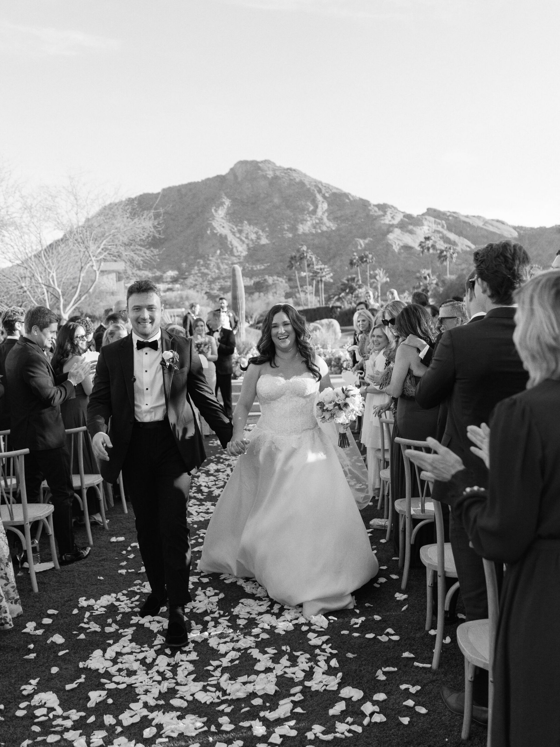 Taylor and Ryan walking back up the petal-strewn aisle after the ceremony.