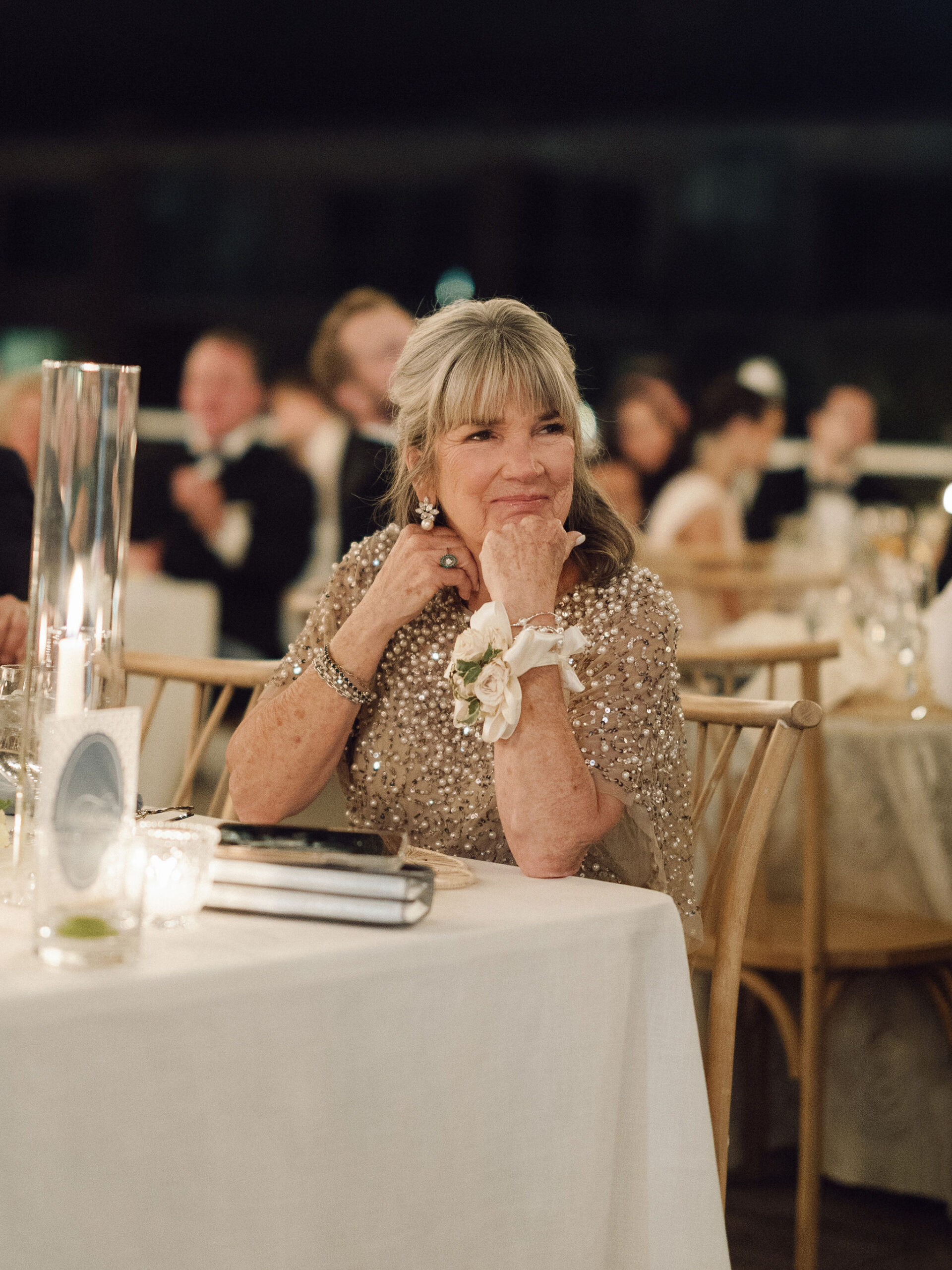 Taylor’s mother watching the evening celebrations from her table.