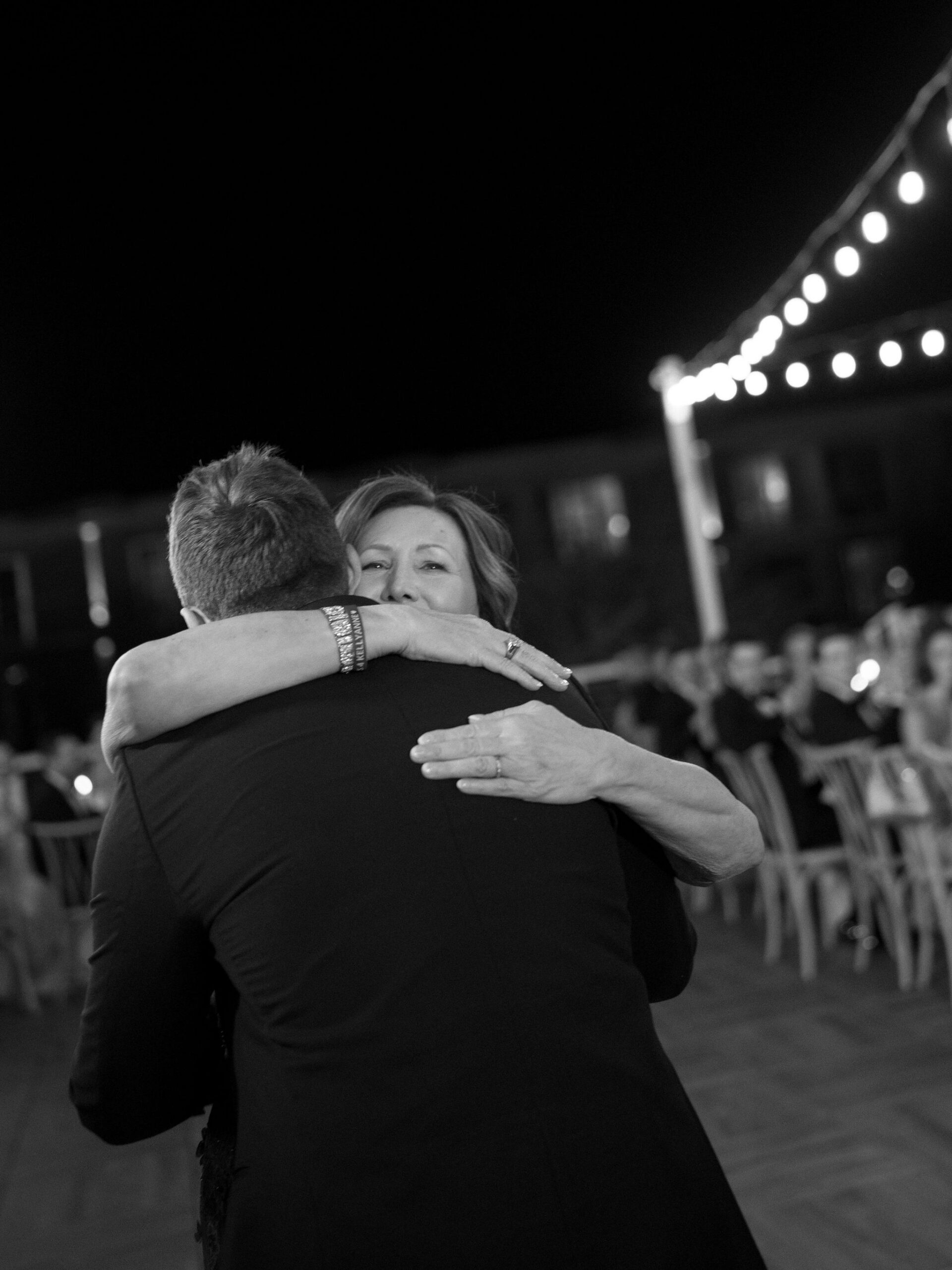 Ryan embracing his mother during their dance in black and white.