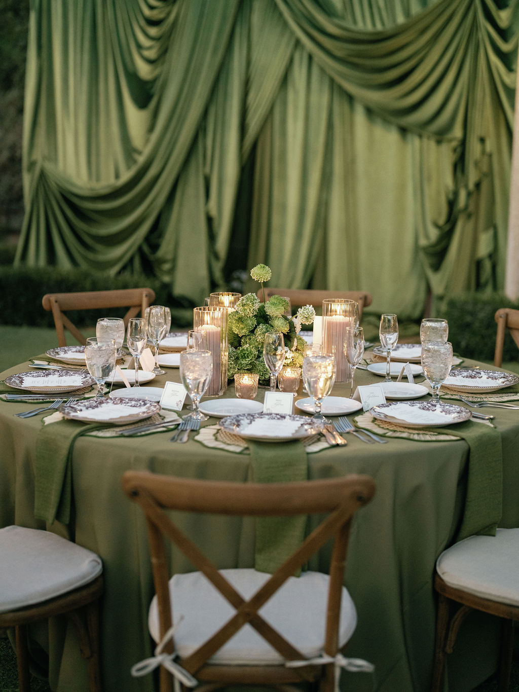 Reception tablescape against a green backdrop