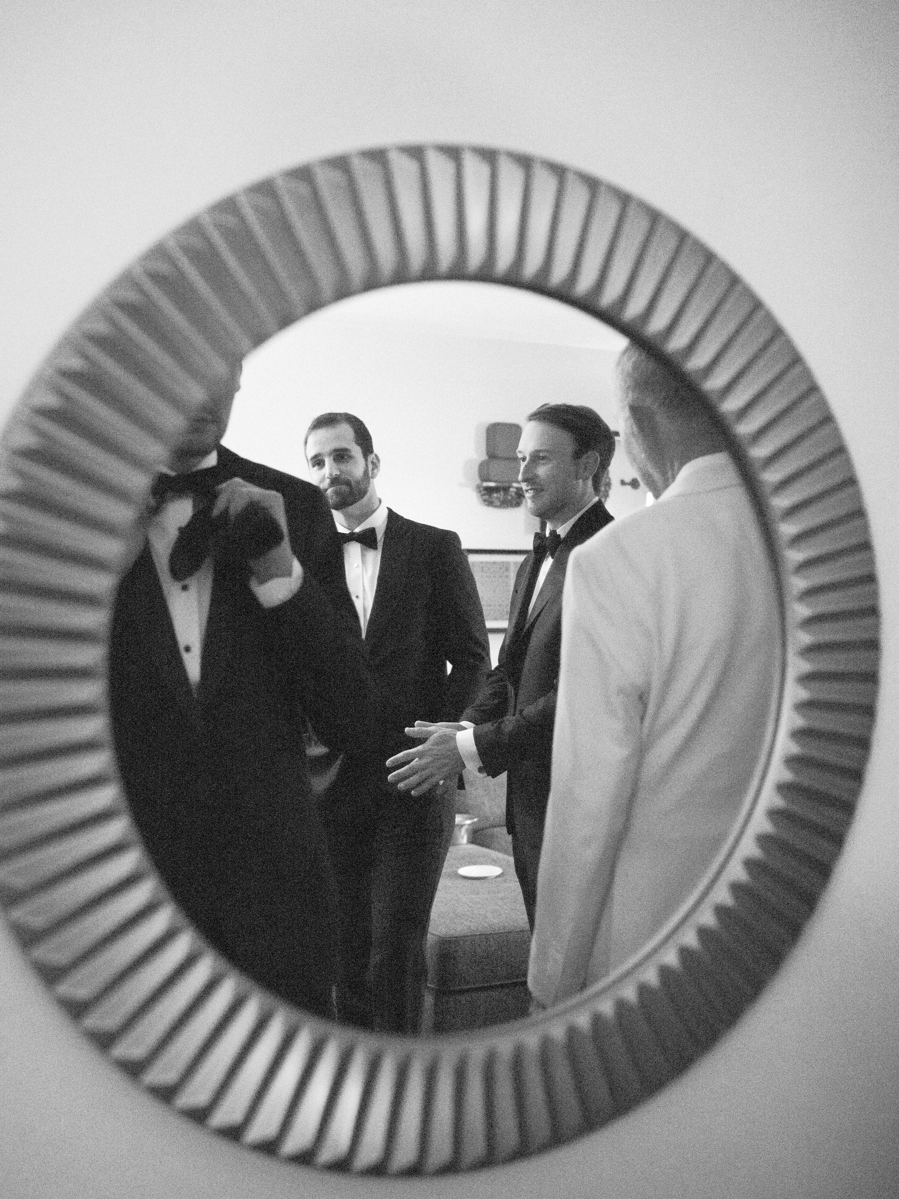 Peter and friends reflected in a round mirror while getting ready