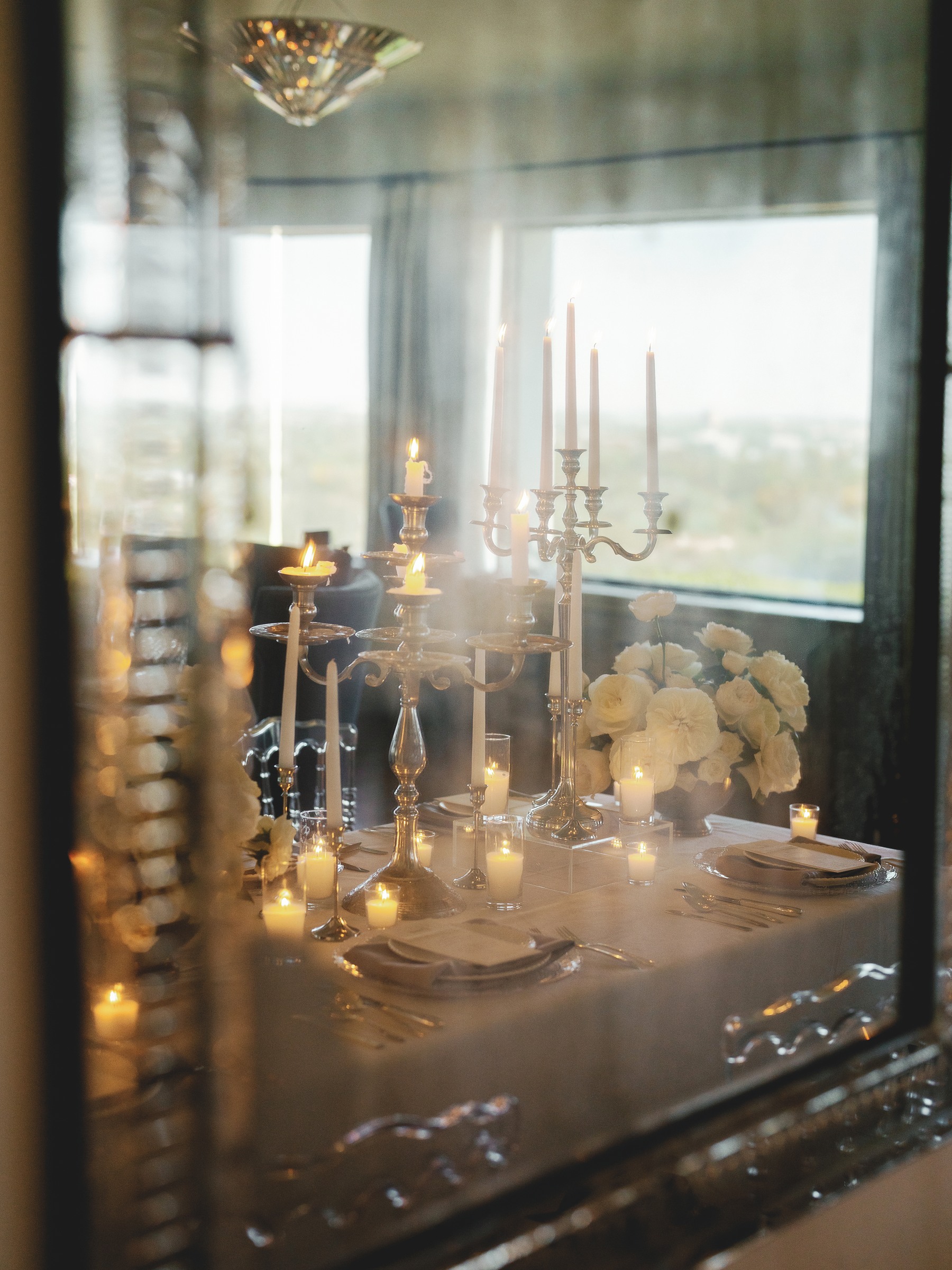 Candlelit dining table reflected in an antique mirror at the Wrigley Mansion in Phoenix