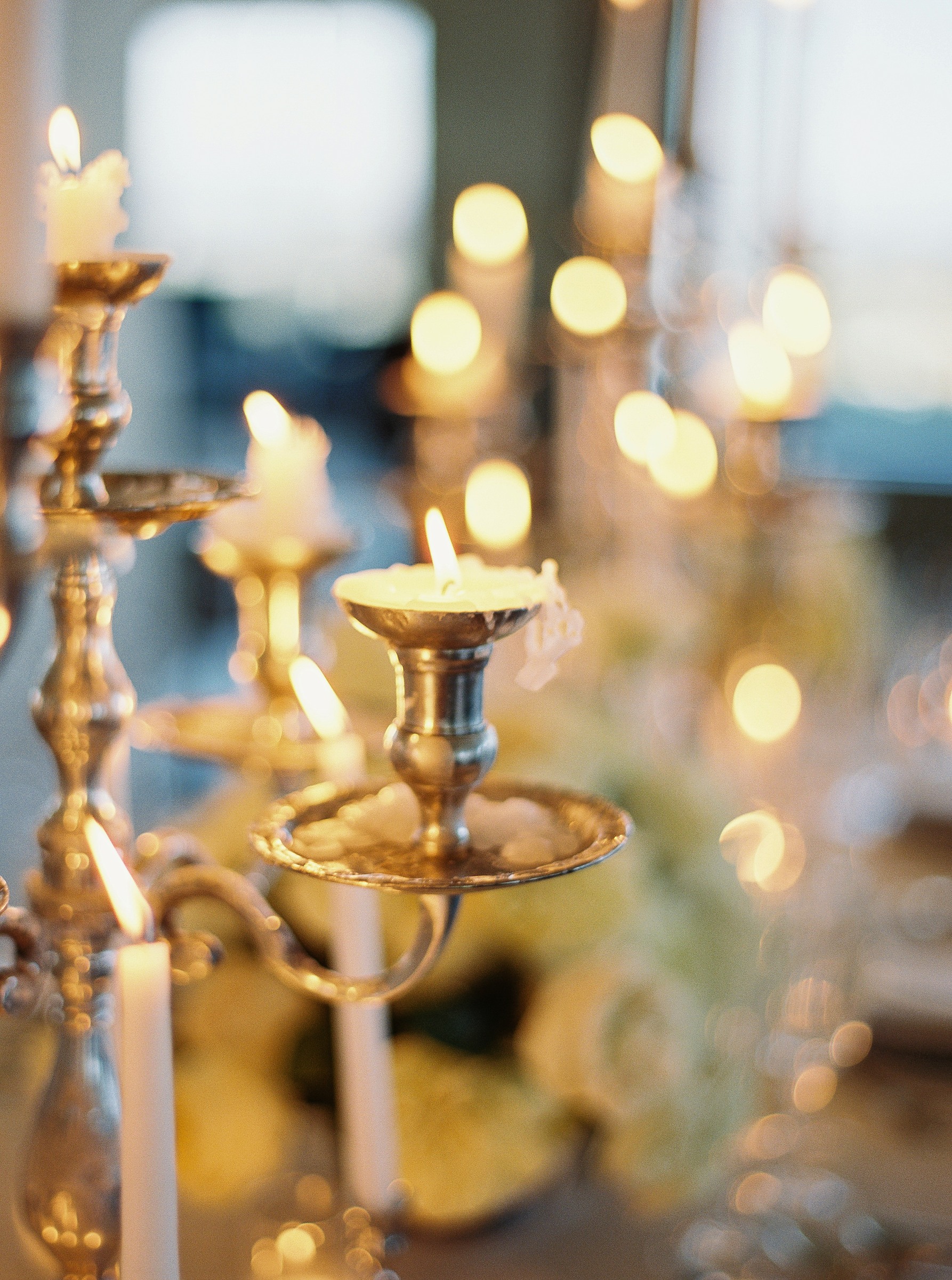 Close-up of a gold candelabra with glowing candlelight